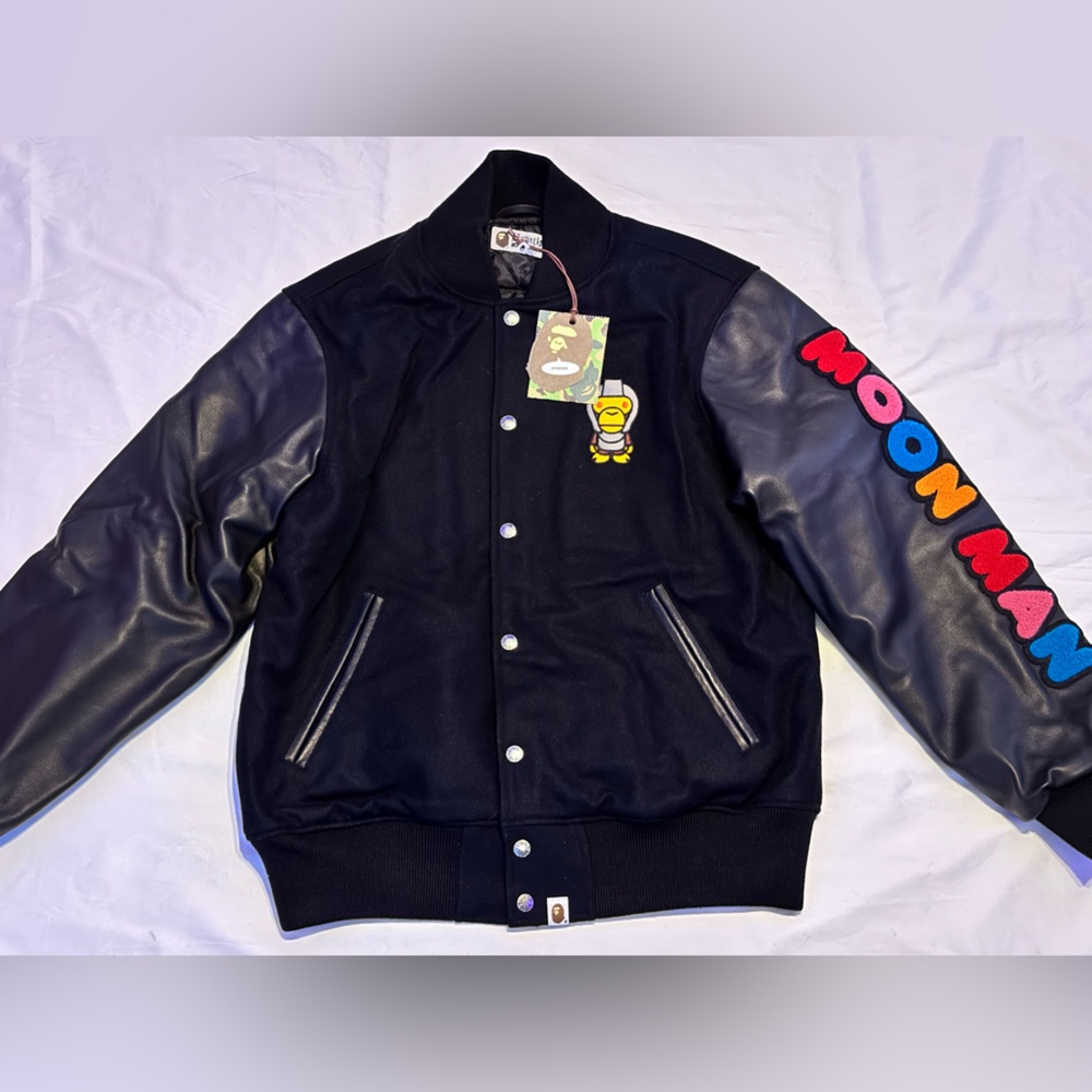 BAPE x Kid Cudi Varsity Jacket in black with genuine leather sleeves